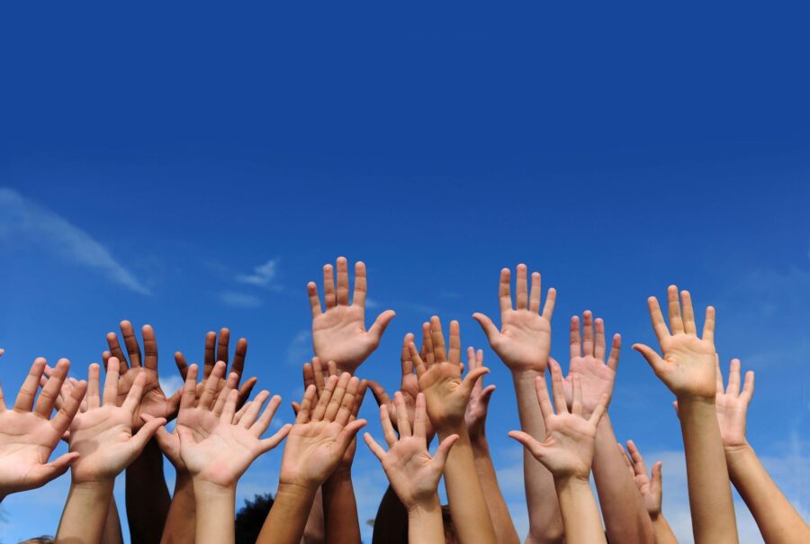 image of dozens of hands reaching into a blue sky | disability inclusion and advocacy in the AbilityOne program