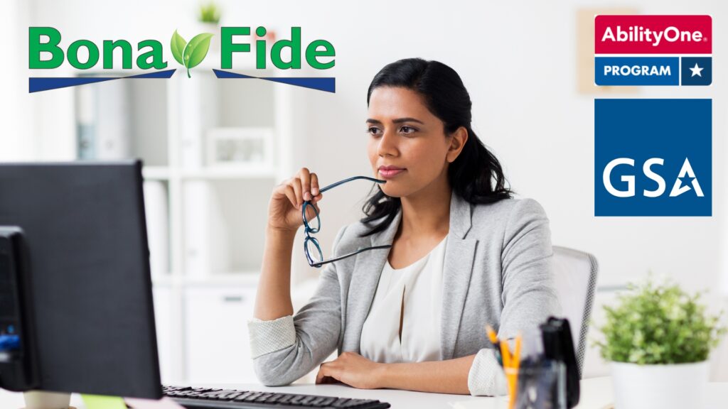 Professional woman sits thoughtfully at her desk while looking at her computer | AbilityOne TFM contractor